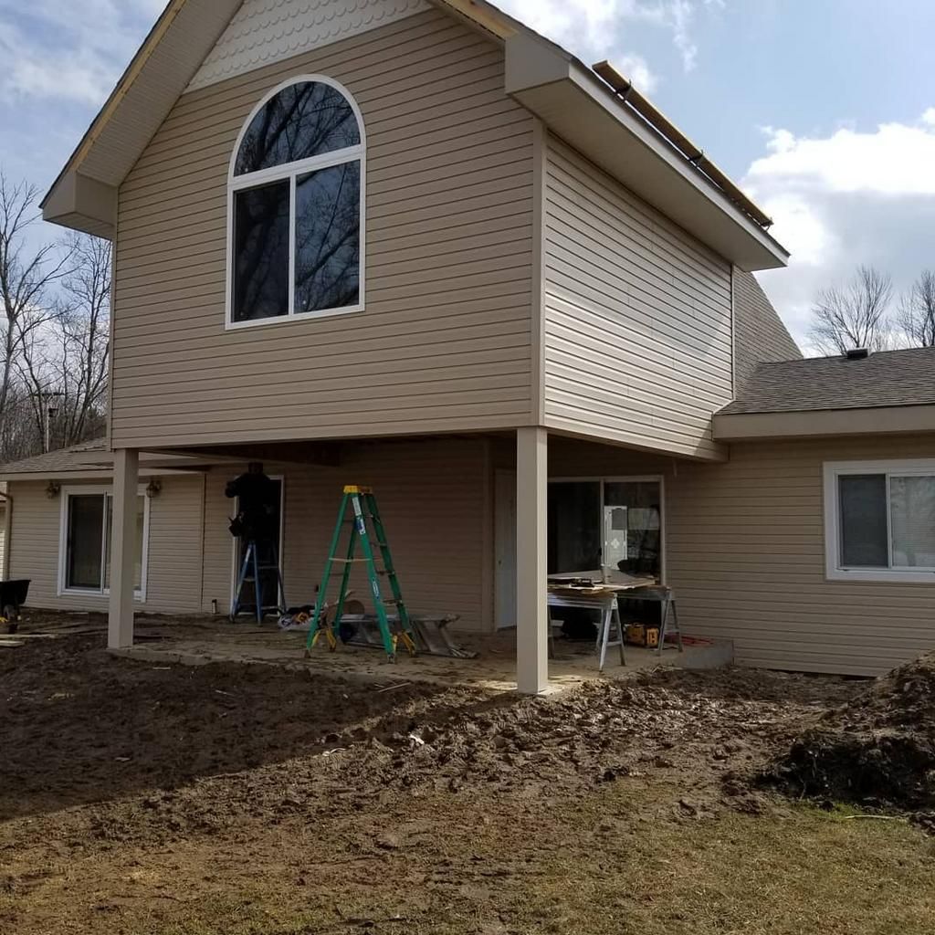 A house with a green ladder in front of it