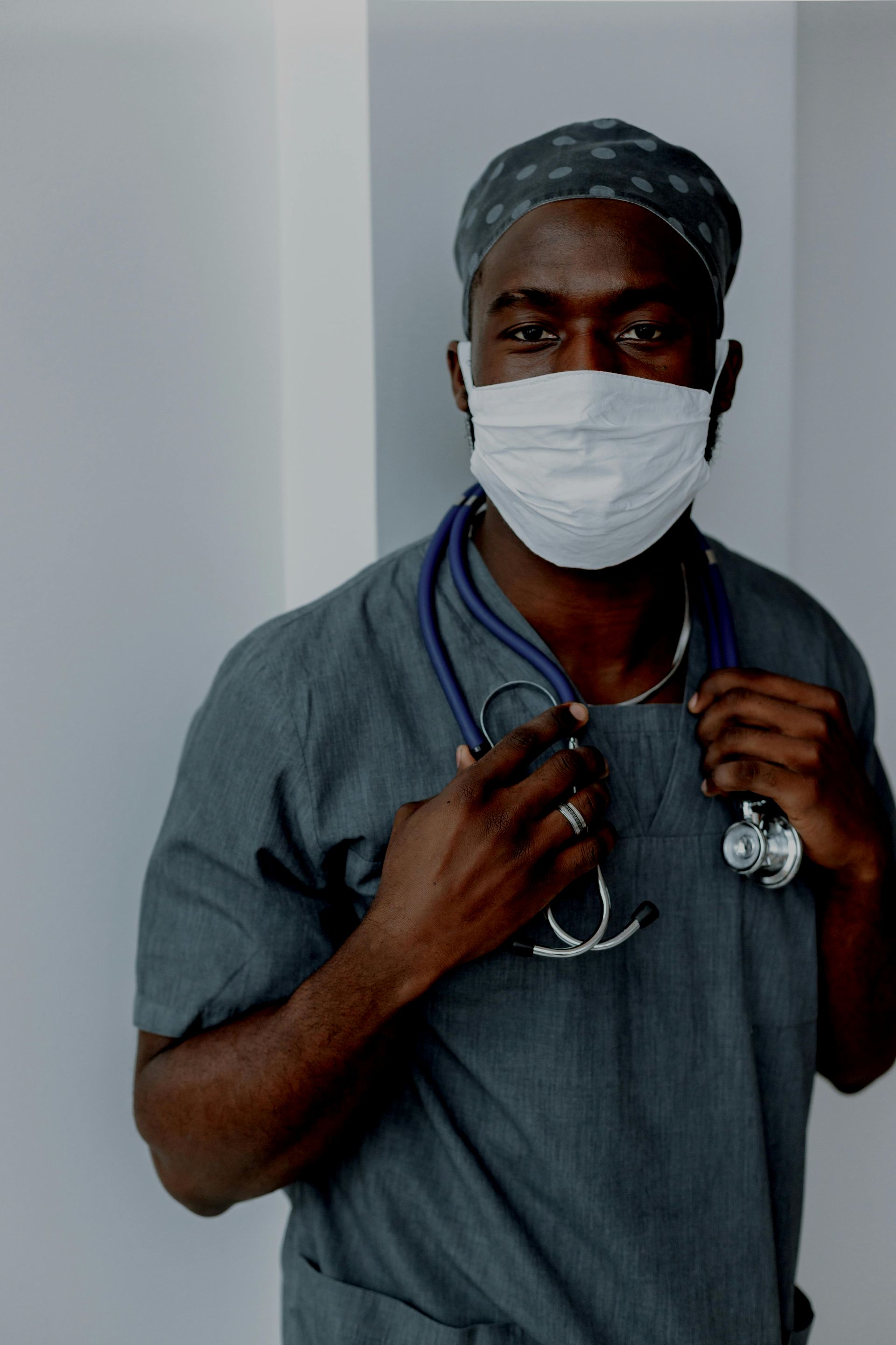 A man wearing a mask and a stethoscope around his neck