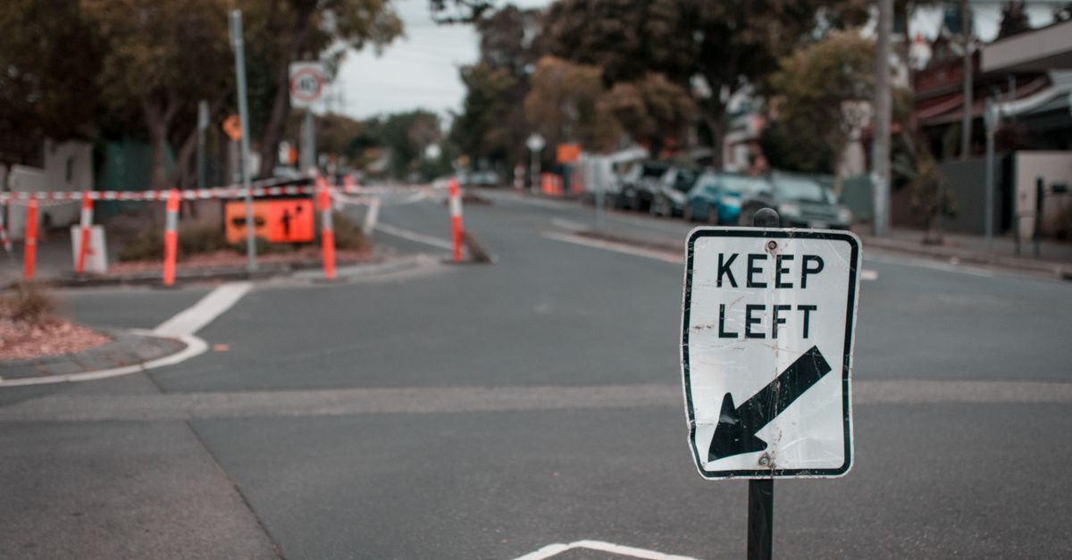 Street with roadworks and a “KEEP LEFT” sign in the foreground