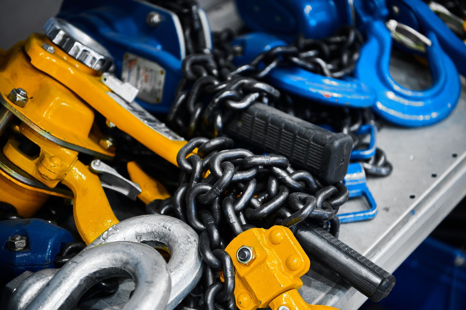 Assorted rigging equipment organized on a well lit workshop table.
