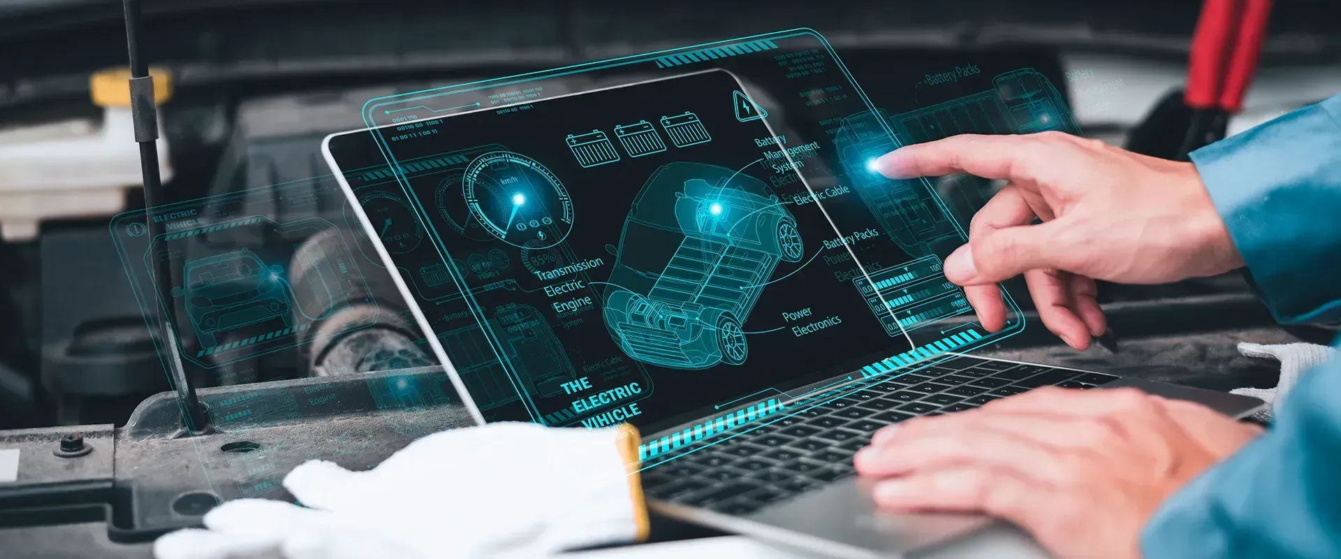 A mechanic uses a laptop displaying a car engine diagnostic diagram while working on a vehicle.