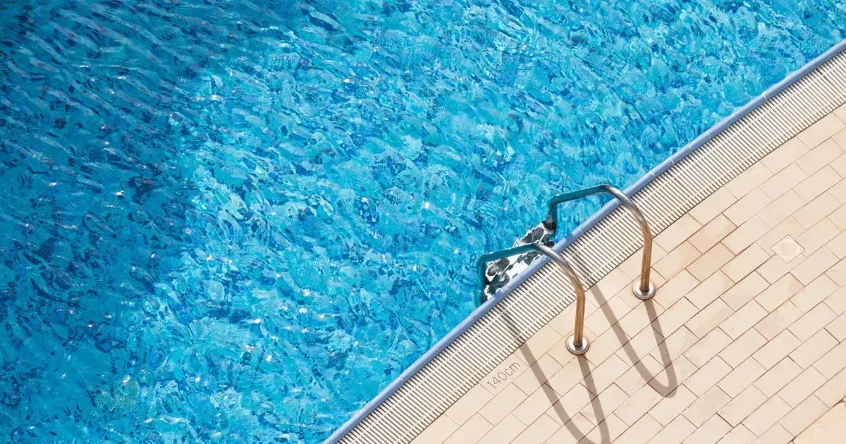 rectangular granite pool with new blue mosaic tile liner