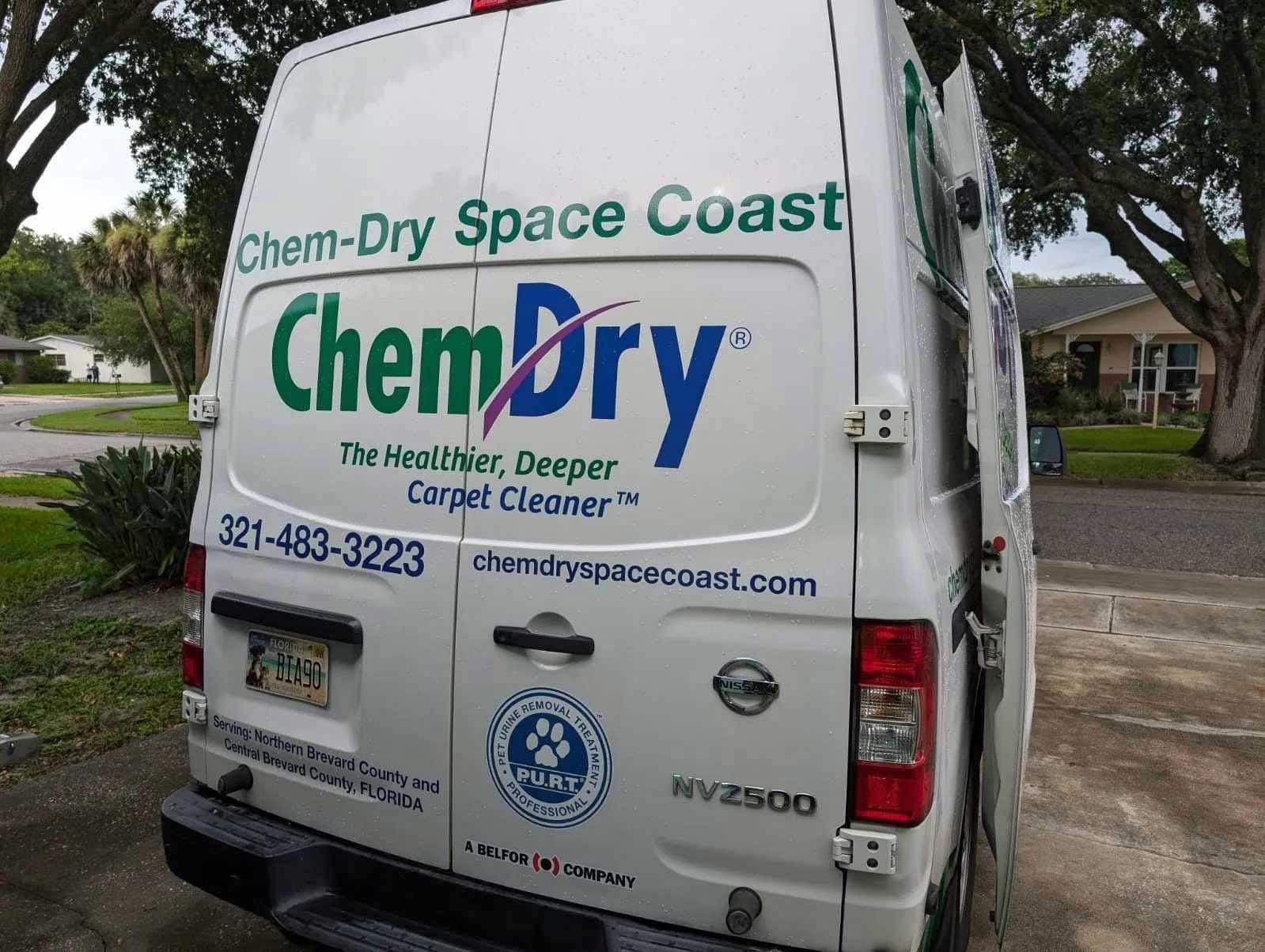 A Chem-Dry van with the logo parked outdoors.