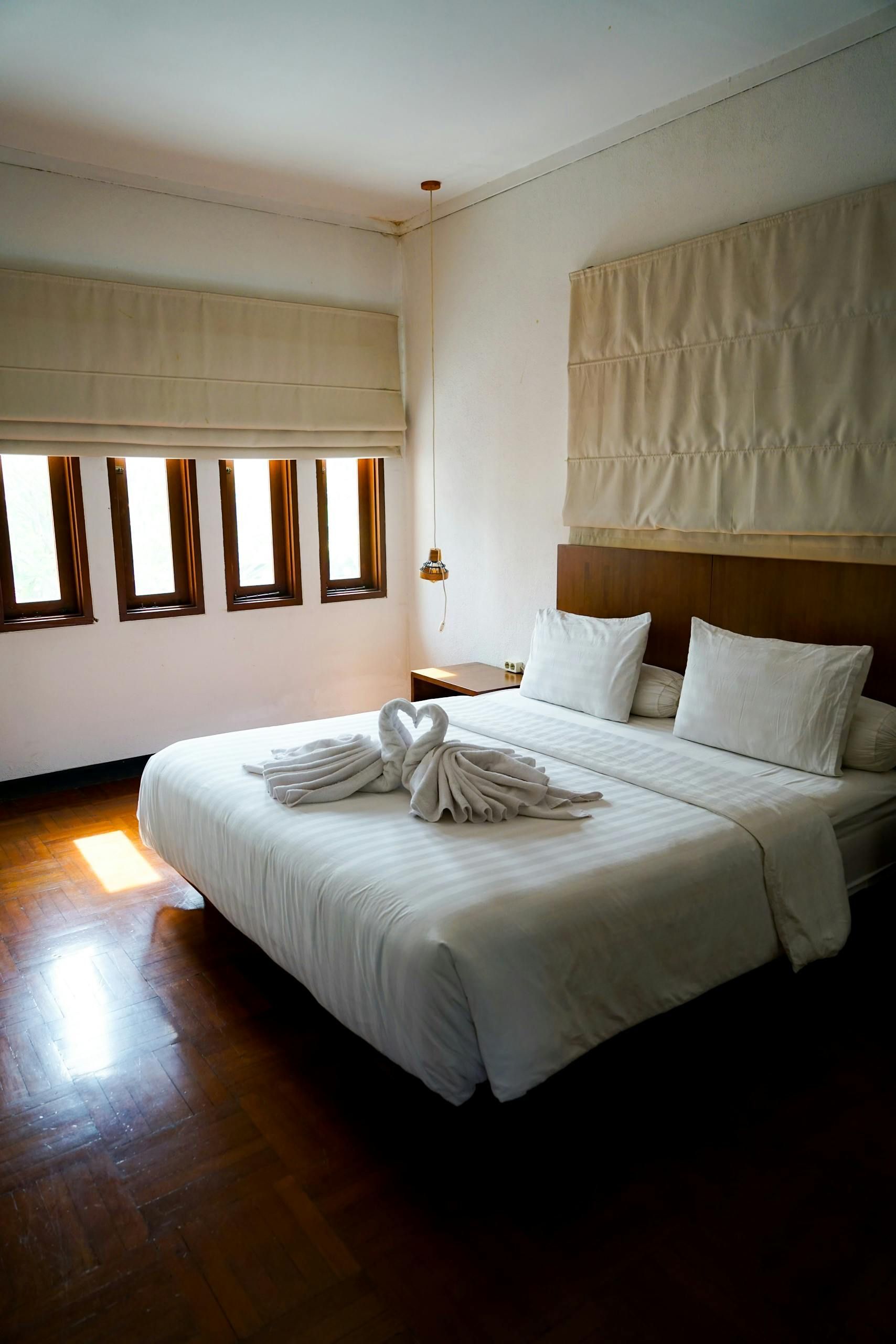 Neat bed in a bright room, emphasizing hidden allergens in mattresses.