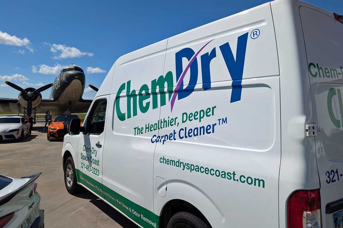 A Chem-Dry van with logo parked outdoors.
