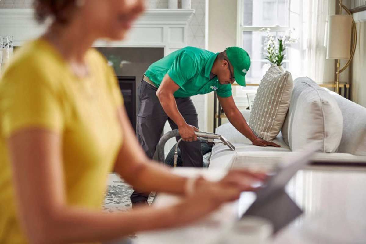 A Chem-Dry technician is cleaning the sofa, improving air quality, and removing allergens.