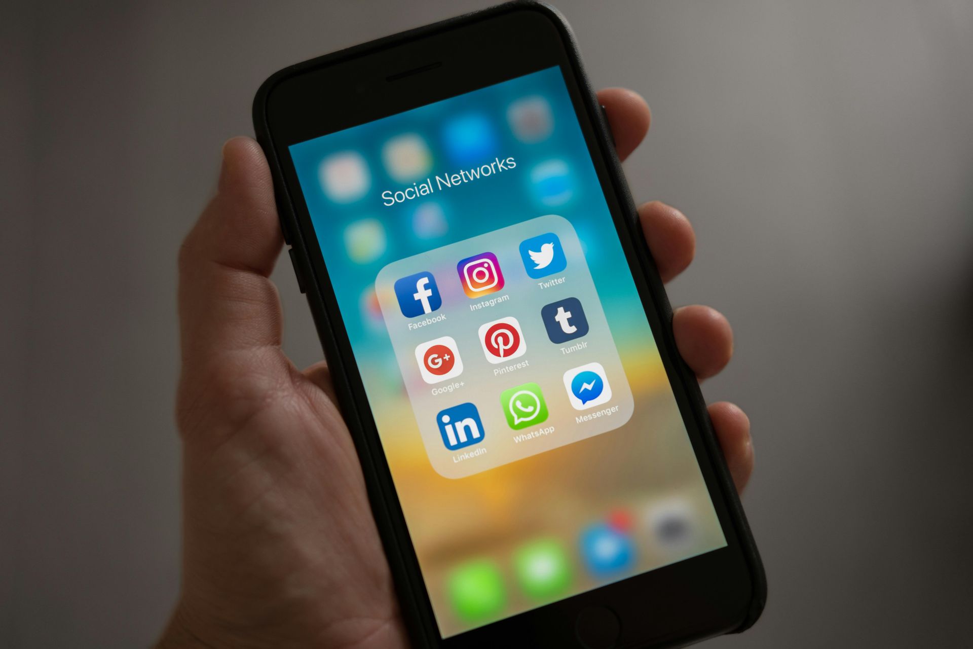 A cell phone displaying the coffee shop on a wooden table.