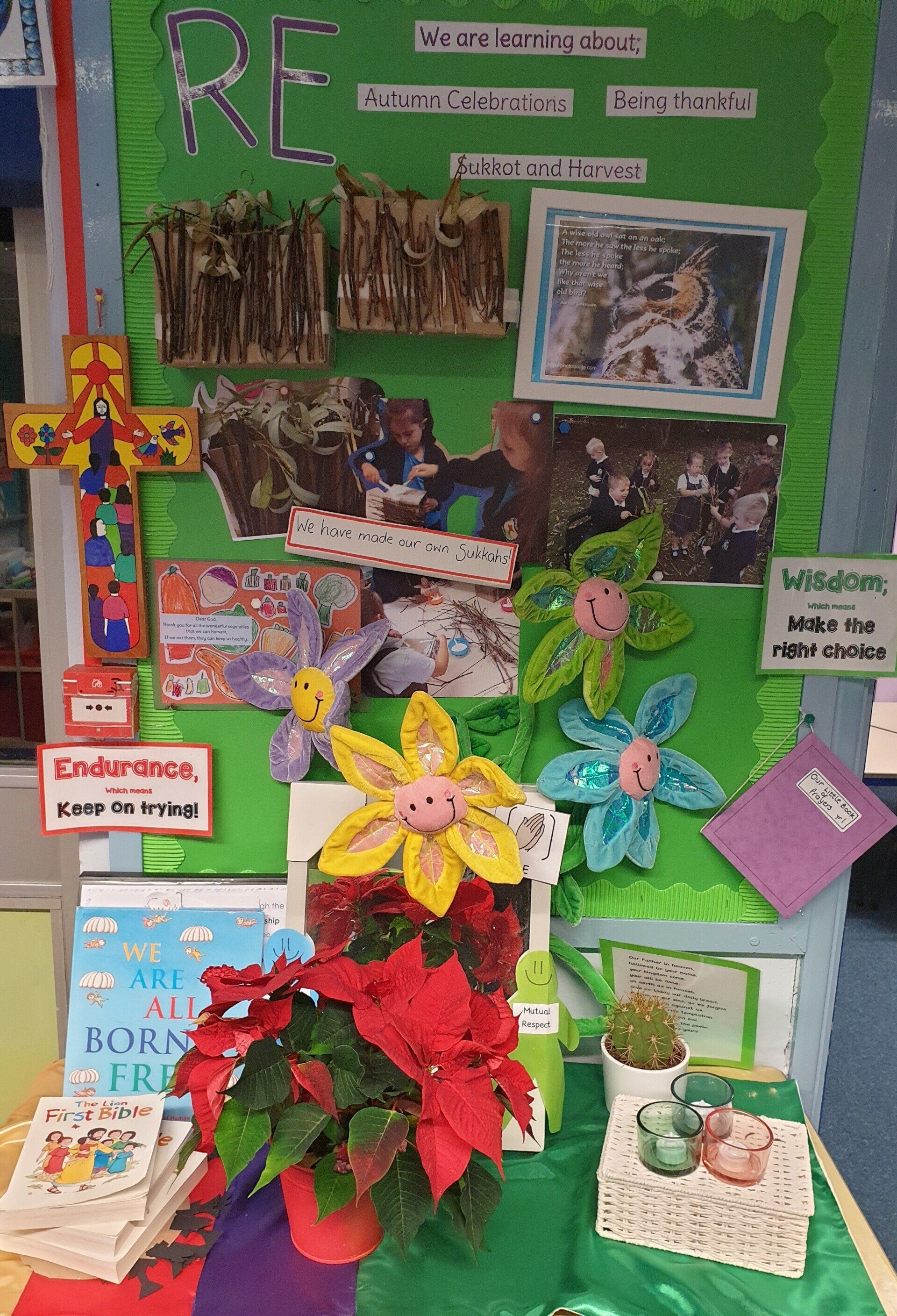 RE display with cross, photos, flowers, books, and poinsettia.