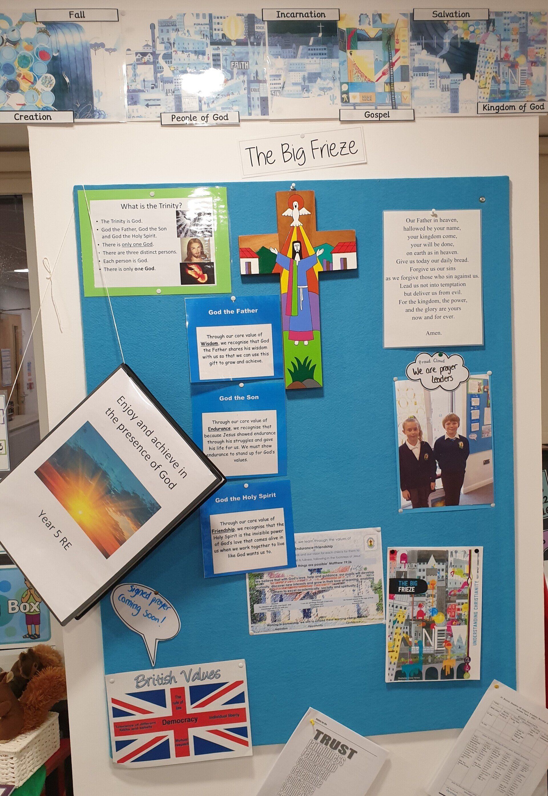 A bulletin board with religious and educational content, including a cross and text.