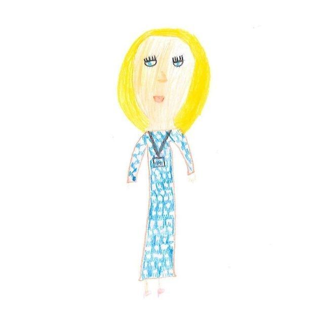 Blonde-haired person wearing blue patterned dress and lanyard.