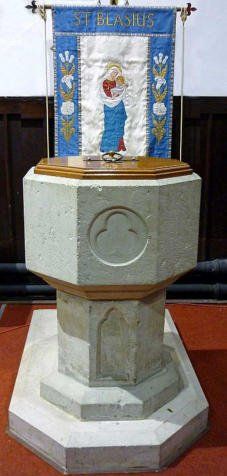 Baptismal font with banner that reads, 