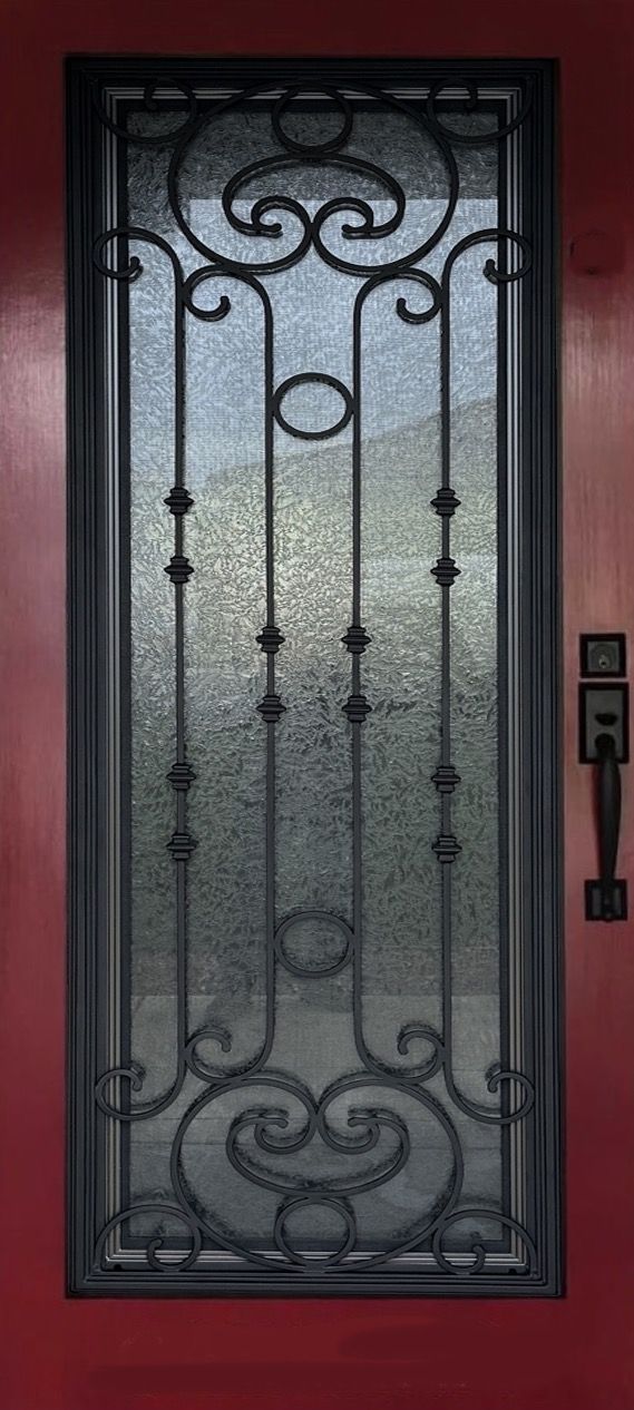 A red door with a wrought iron design on it
