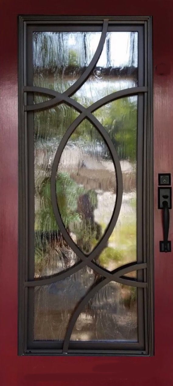 A wrought iron door with a circular design on it.