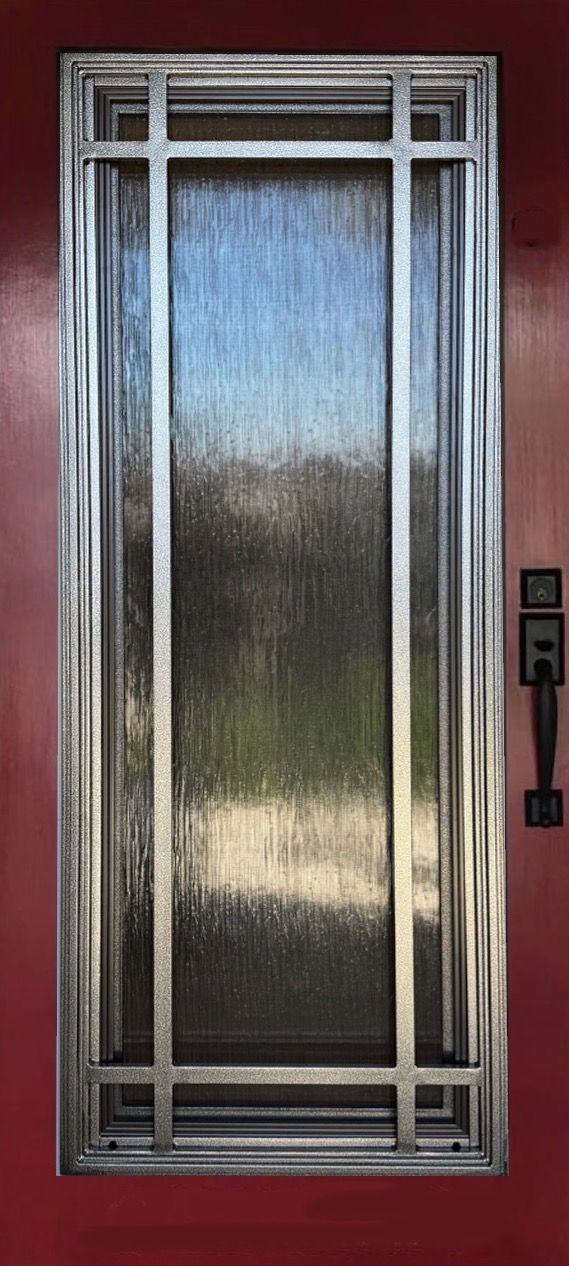 A close up of a door with a window on a red wall.