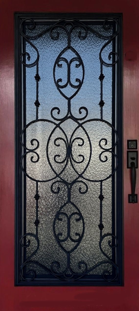 A door with a wrought iron design on it