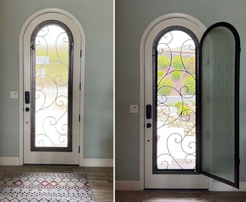 A door with a wrought iron design on it is open and closed.