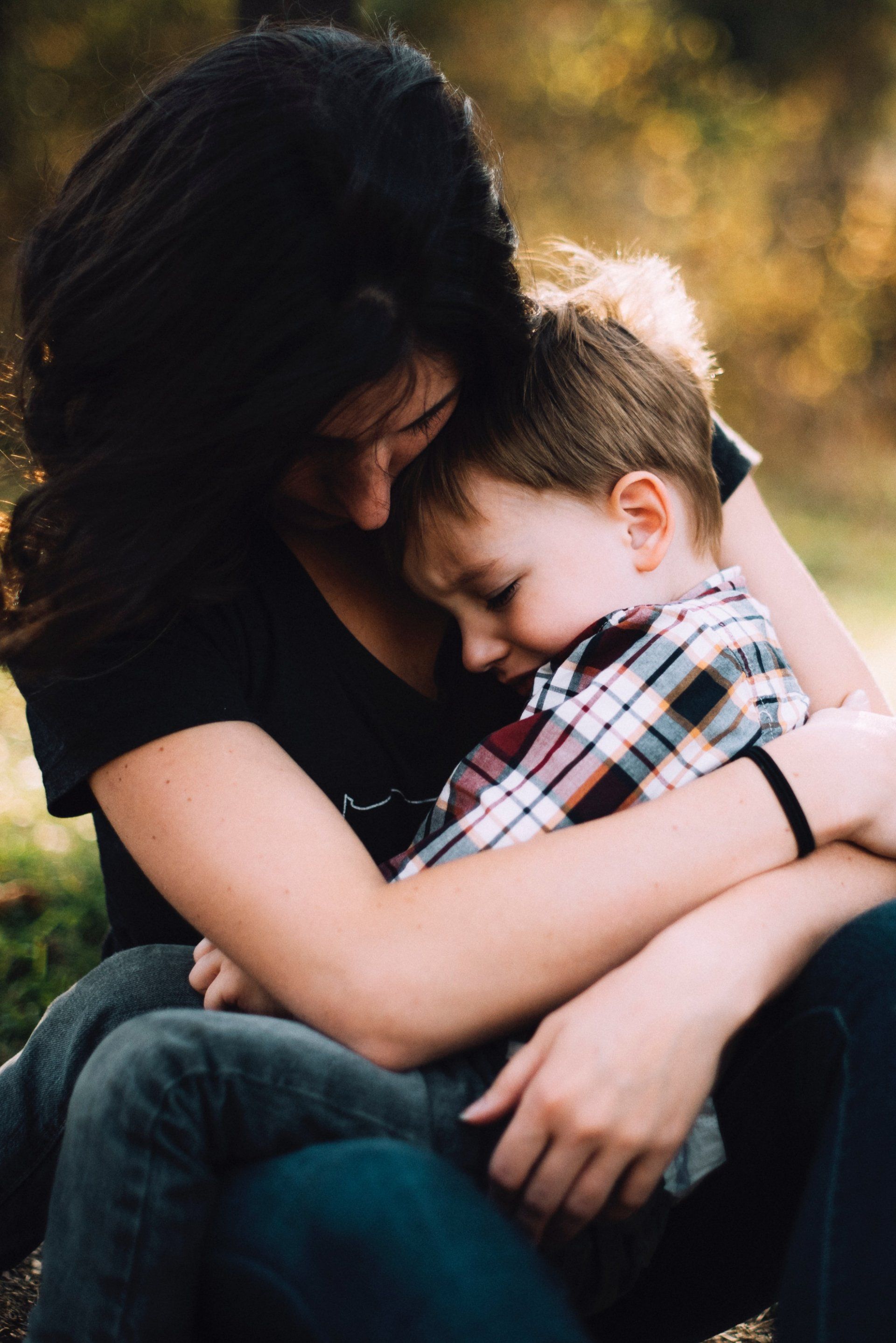 mother comforts crying son