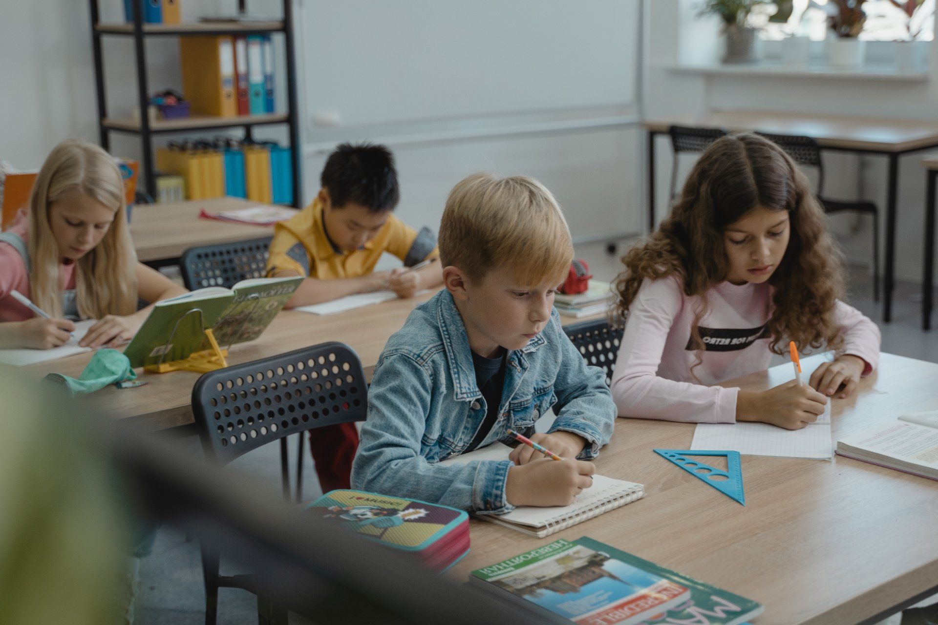 preteen boys and girls in classroom