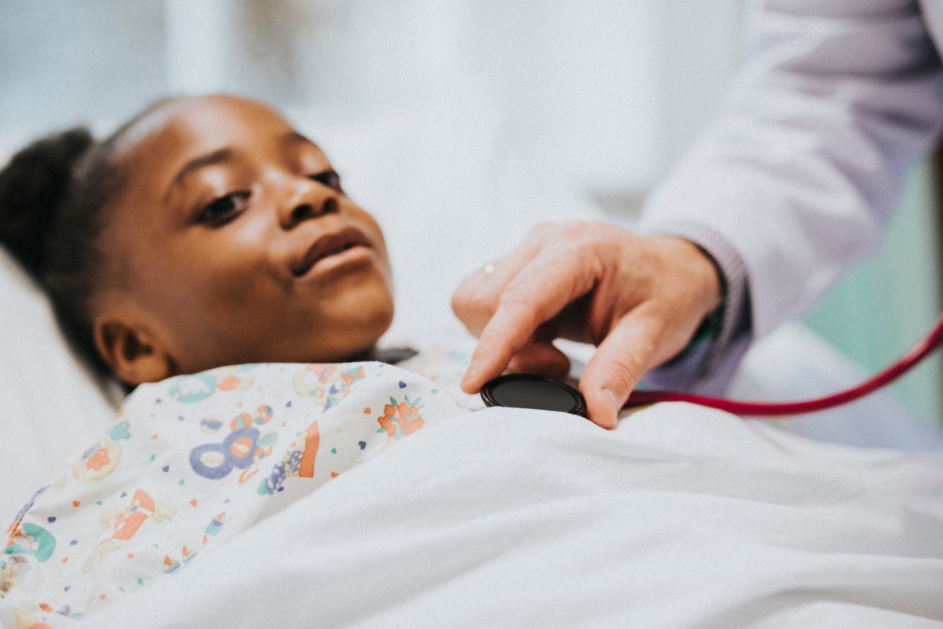 doctor checks girls heartbeat before surgery
