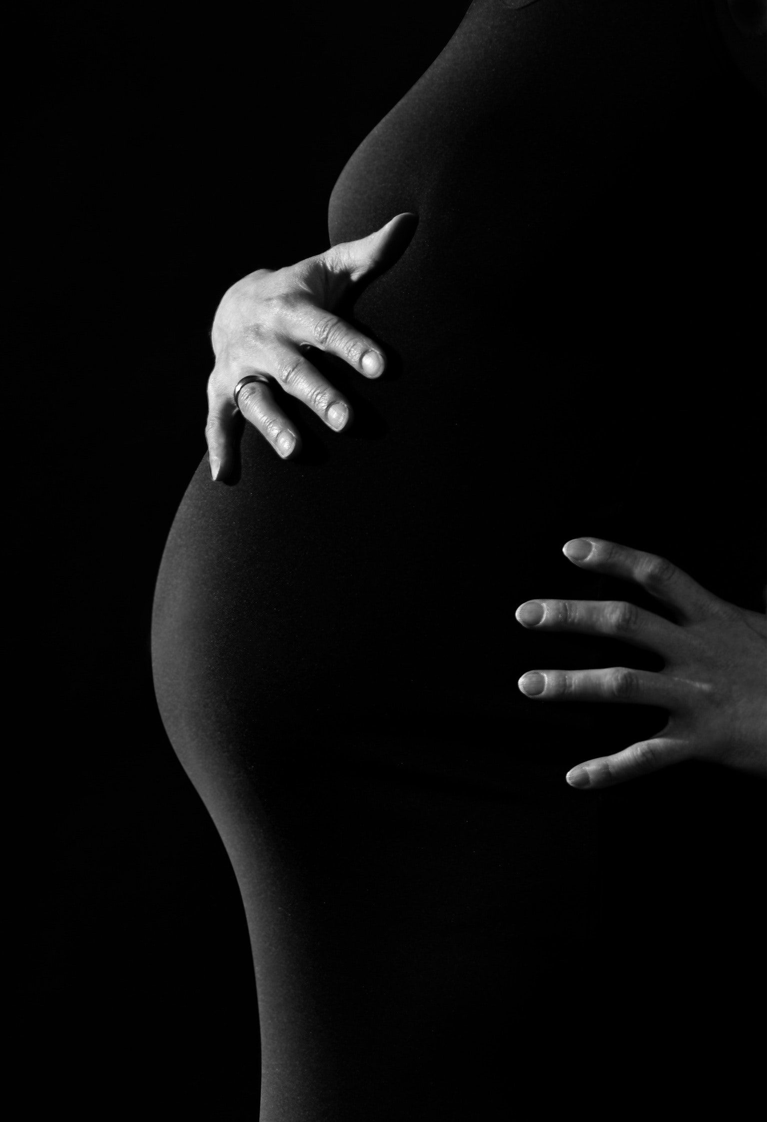 black and white side profile view of pregnant woman