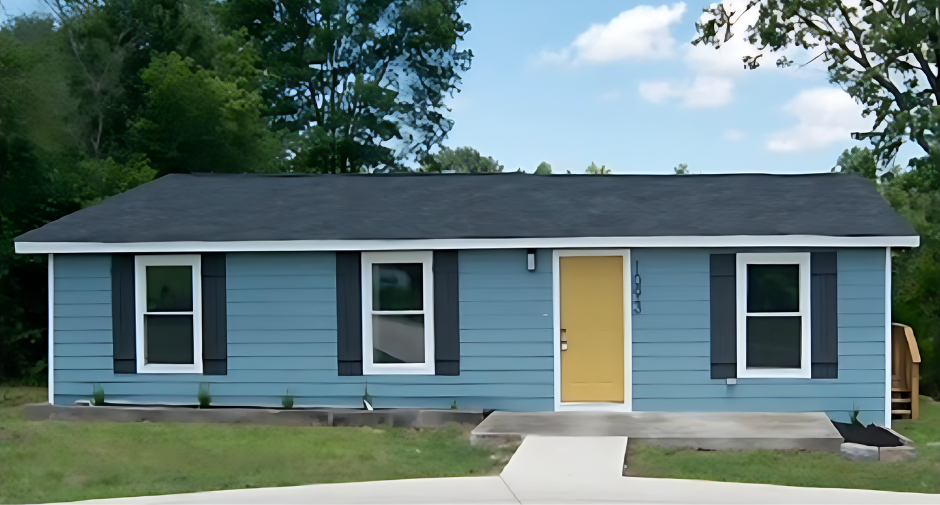 A blue house with black shutters and a yellow door