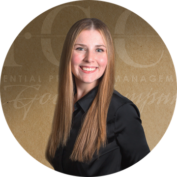 Smiling woman with long brown hair wearing a black shirt.