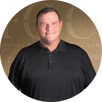 Man smiles, in a black shirt, set against a brown background with text.