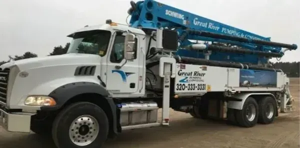 White utility truck with blue equipment parked outdoors on a road