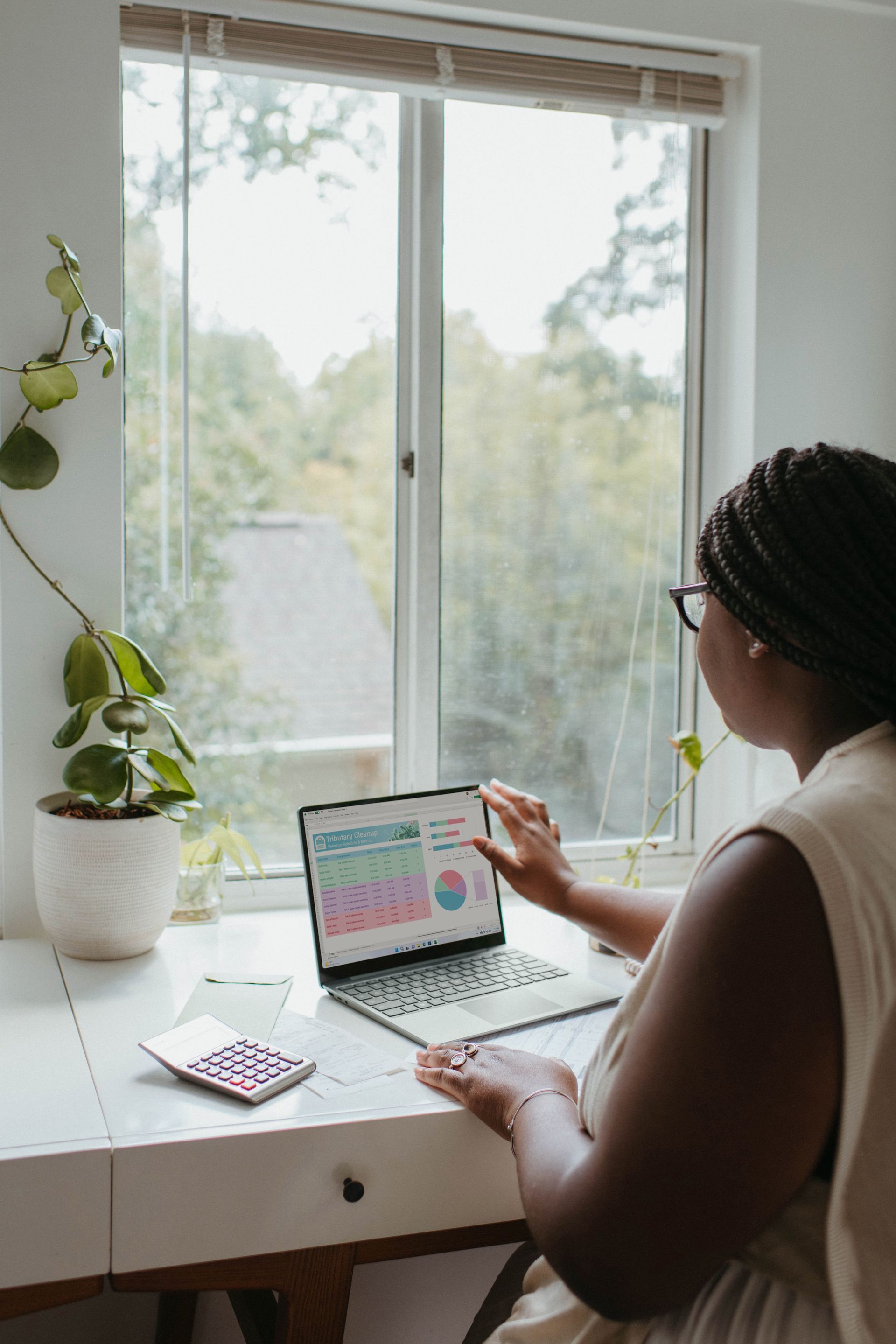 Woman looking at a laptop screen with figures