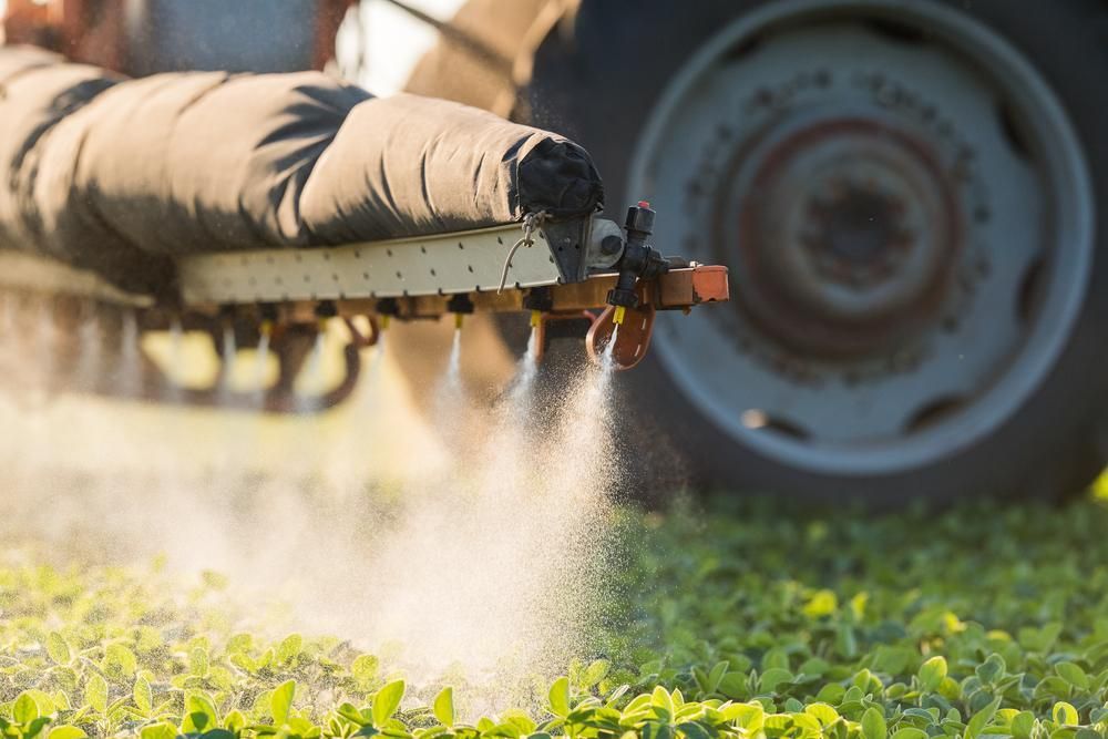 A Tractor Spraying a Field — Parkes Machinery Services PTY LTD in Parkes, NSW