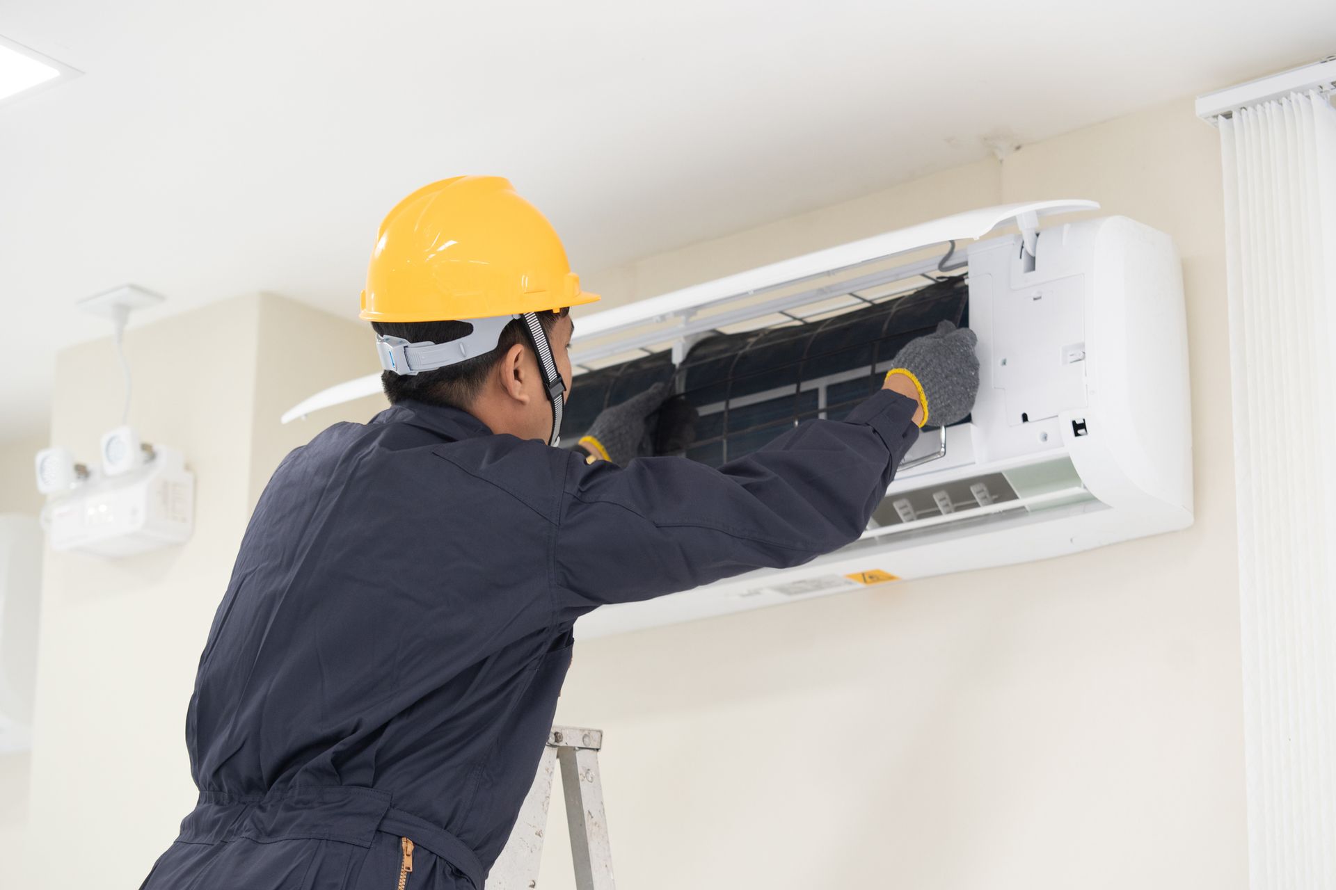 Technician fixing AC unit