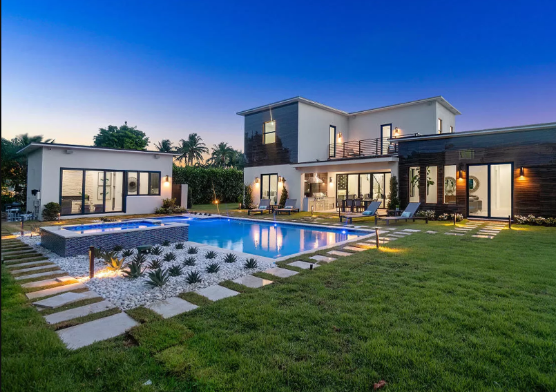 A large house with a swimming pool in the backyard.