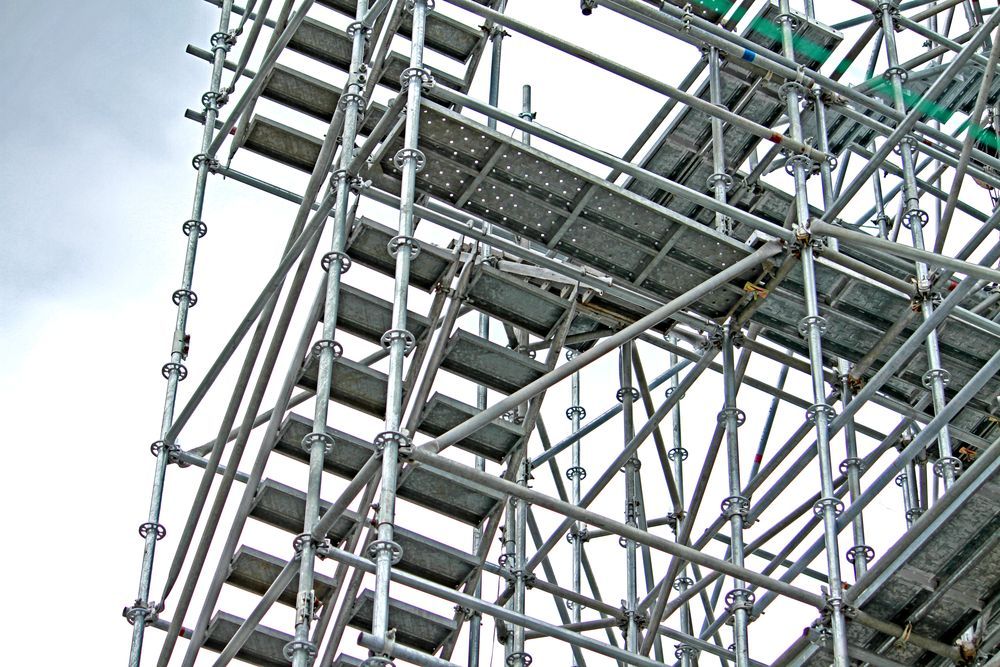 Scaffolding Structure, Gray Metal, Stairs, Walkways, Against a Cloudy Sky, Construction Site — Tincone Pty Ltd in Paget, QLD