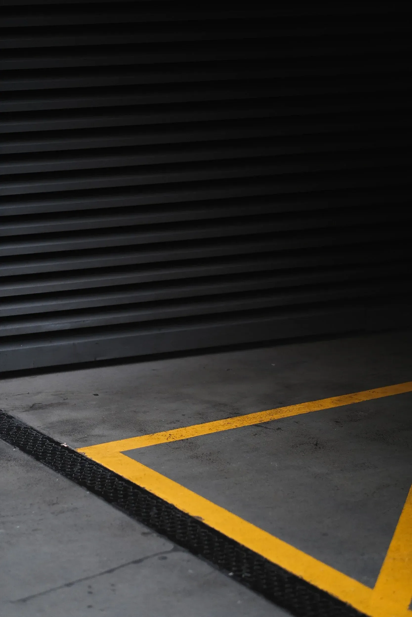 Black and Grey Parking Garage With Yellow Painted Lines — Tincone Pty Ltd in Paget, QLD