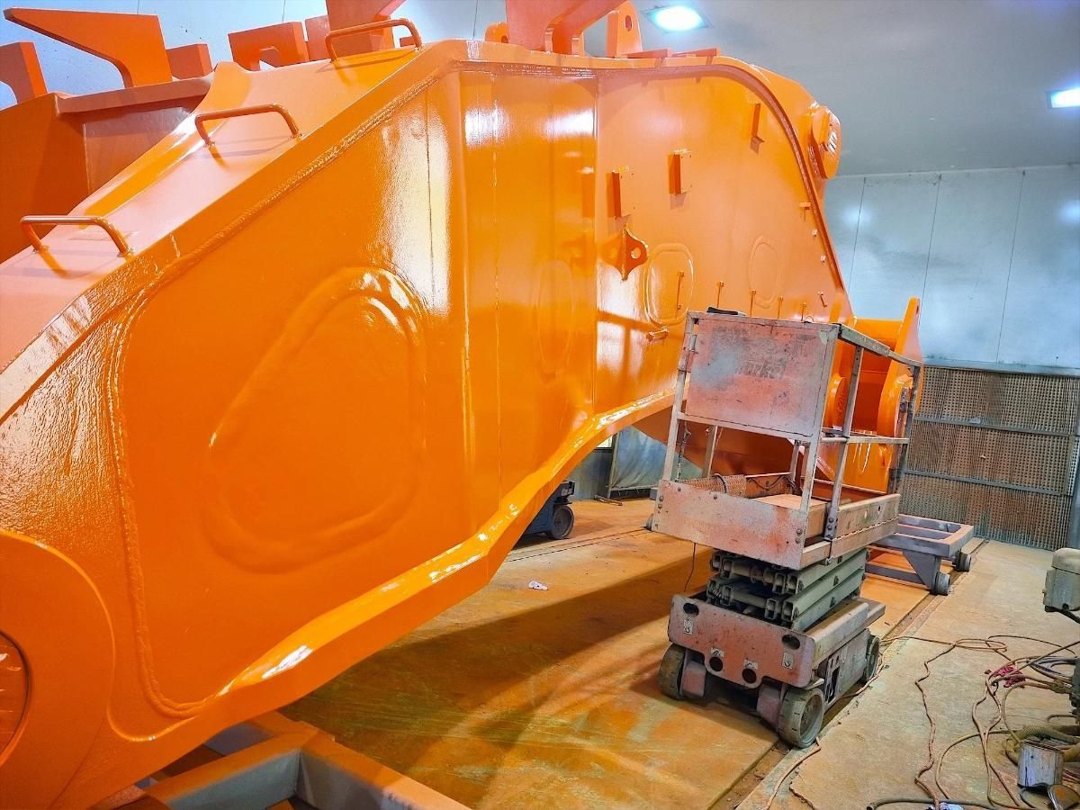 Large Orange Machinery Being Painted in a Workshop — Tincone Pty Ltd in Paget, QLD
