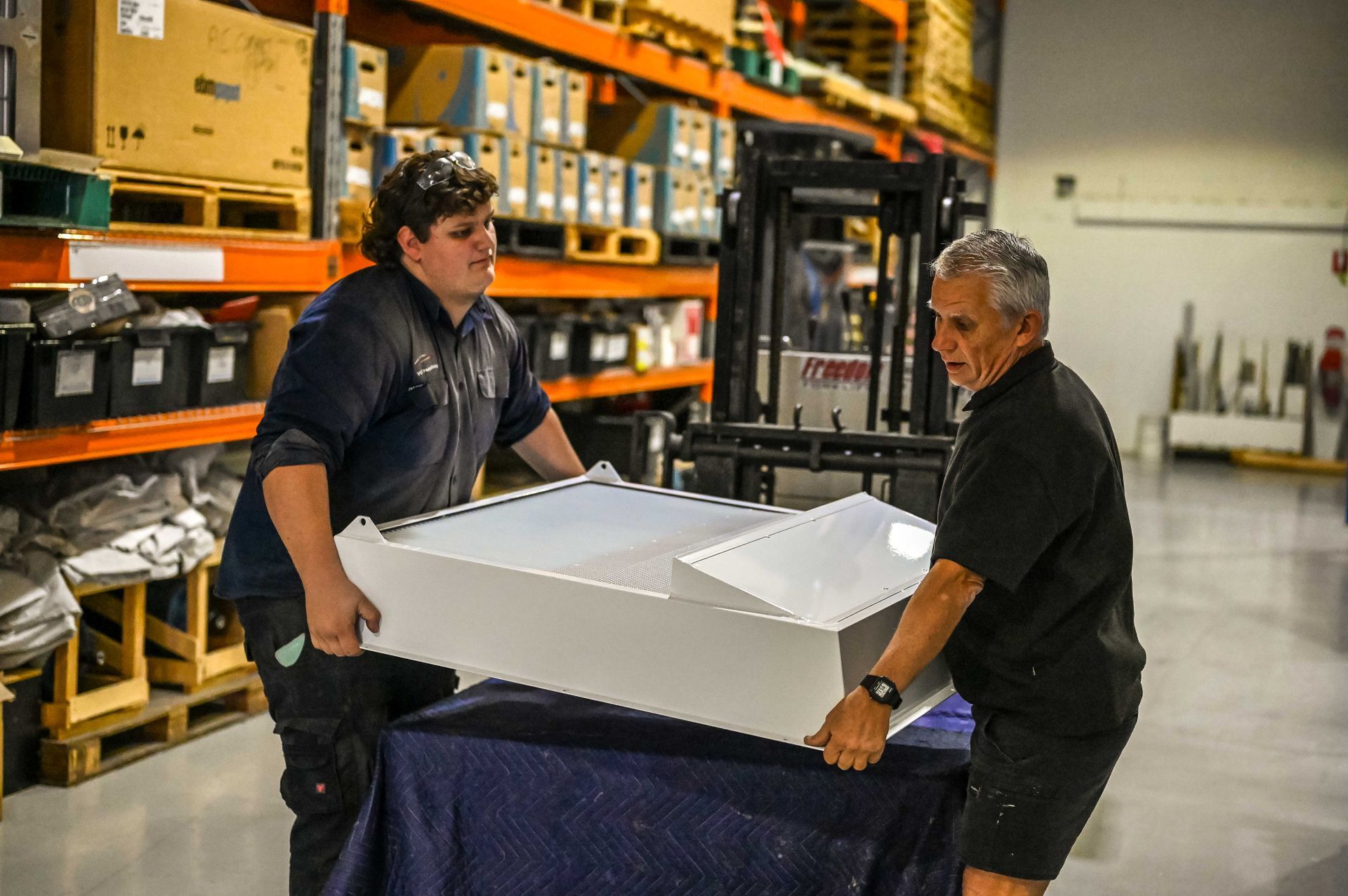 Our team handling a large intake grille with dorade.