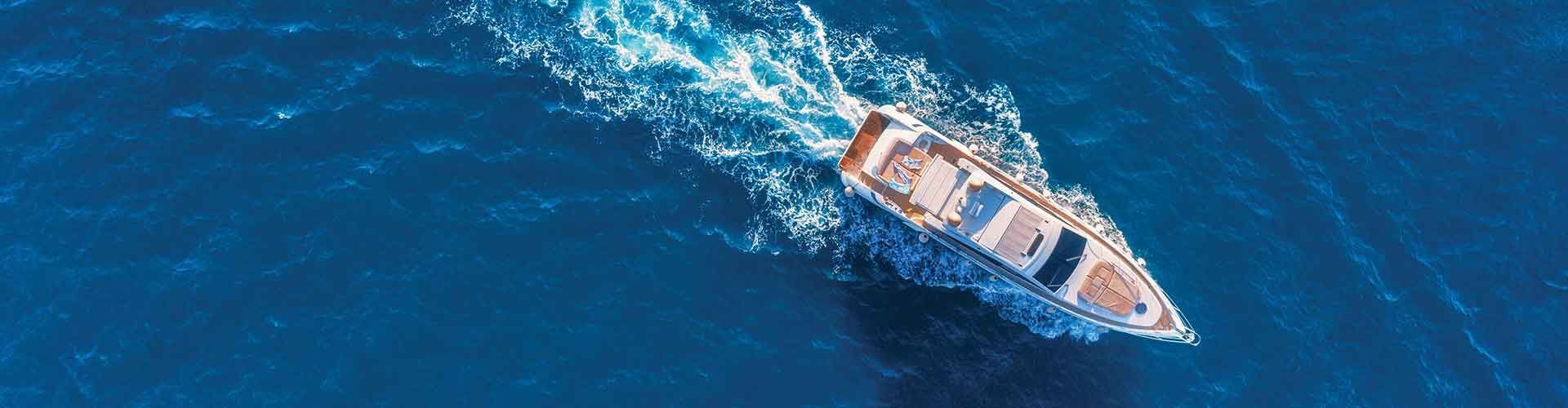 A recreational boat steaming through blue ocean
