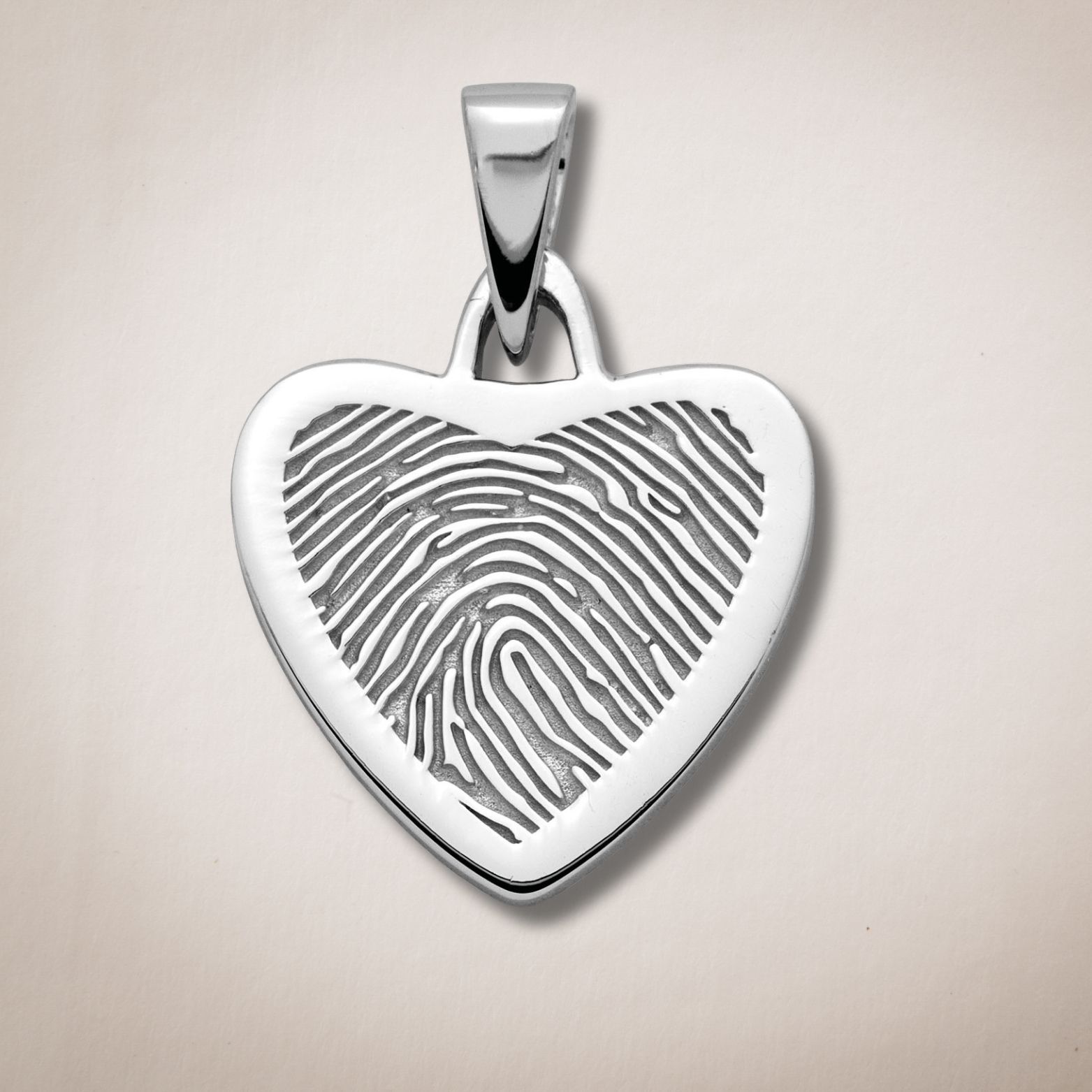 Een hartvormige hanger met een vingerafdruk erop