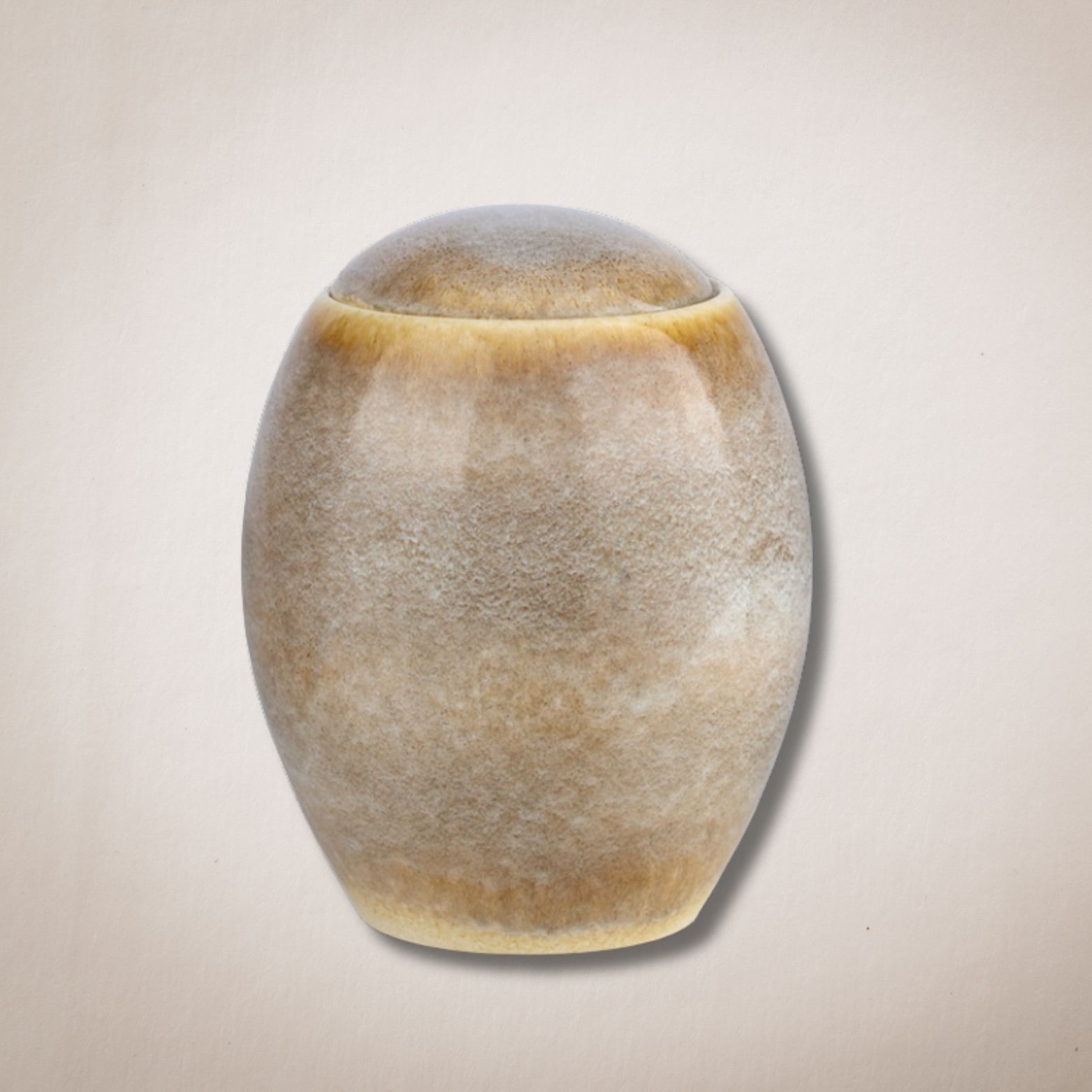 Een kleine keramische urn met deksel op een witte achtergrond.