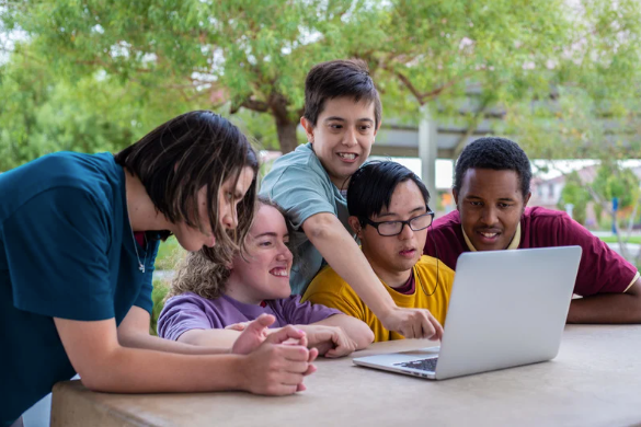 A Group Of Young People Looking At A Computer โ Eleos Support Services In Lavington, NSW
