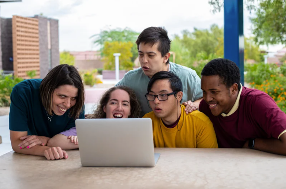 A Group of Young People Looking At A Laptop โ Eleos Support Services In Lavington, NSW