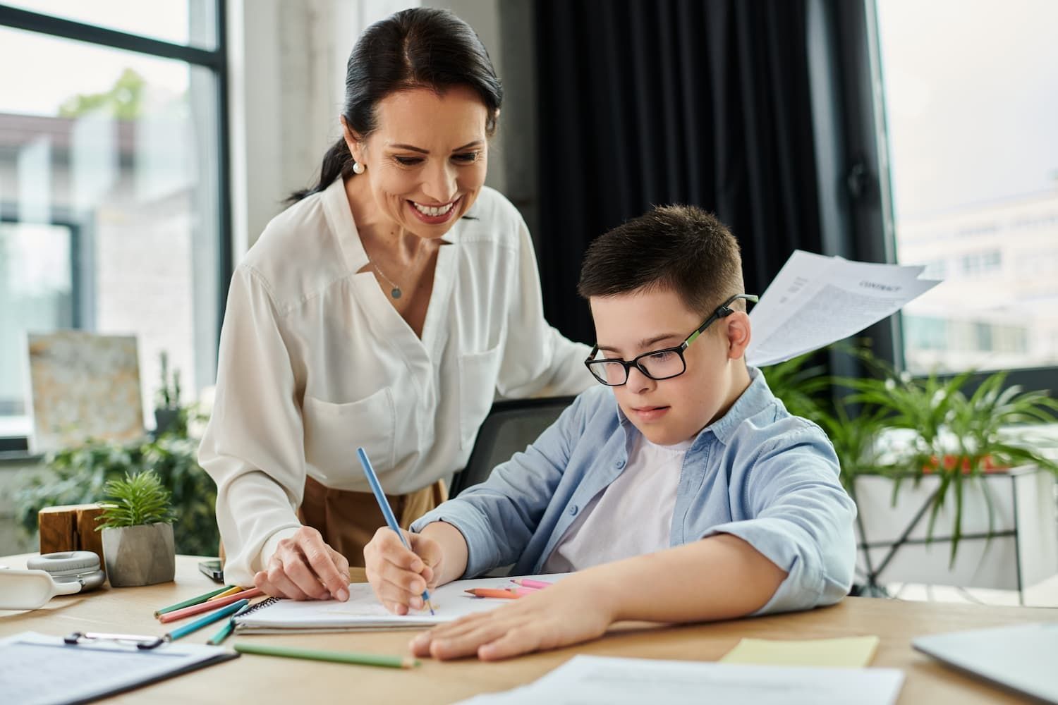 A Woman is Helping a Boy With His Homework โ Eleos Support Services In Lavington, NSW
