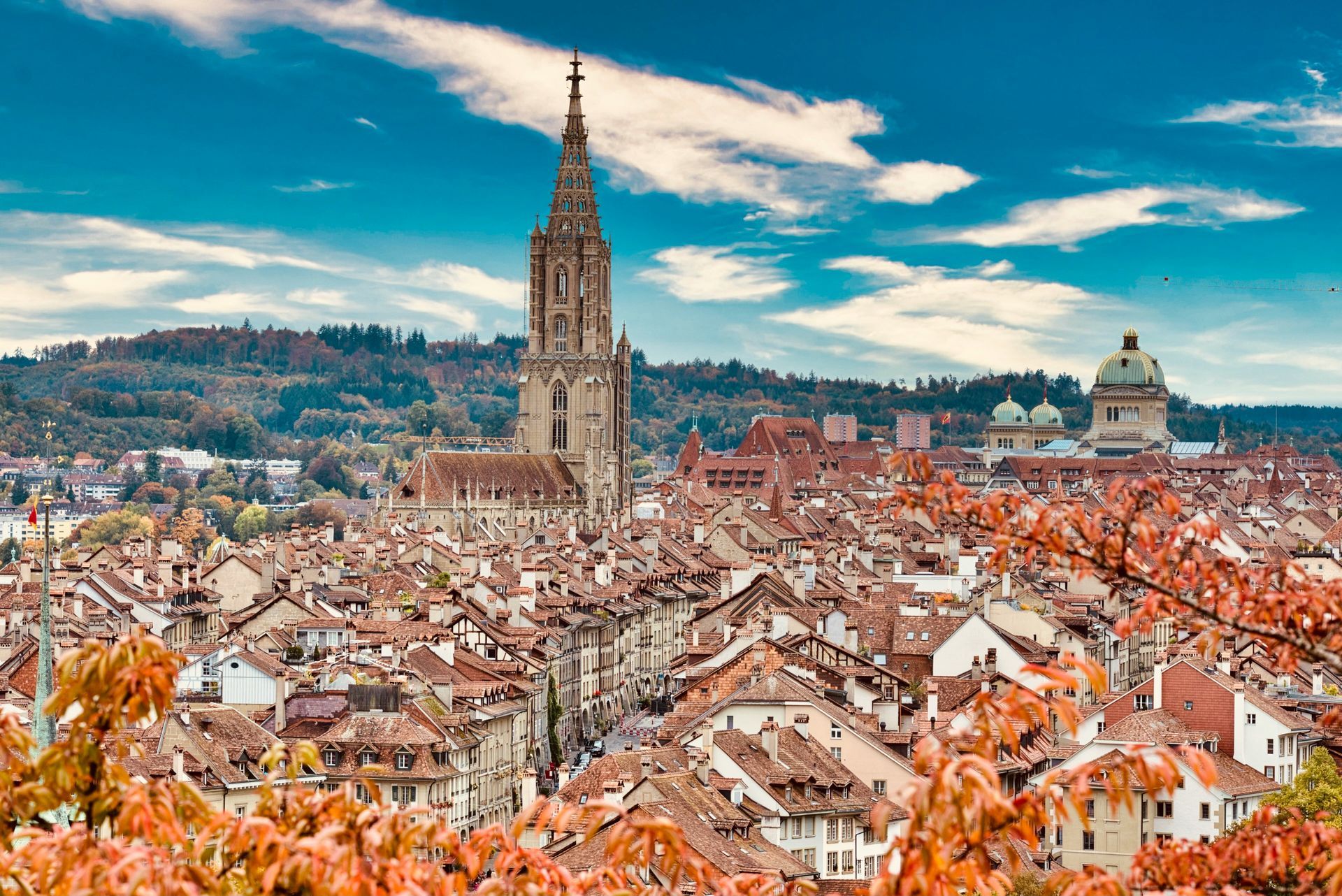 An aerial view of a city with a large tower in the middle of it.
