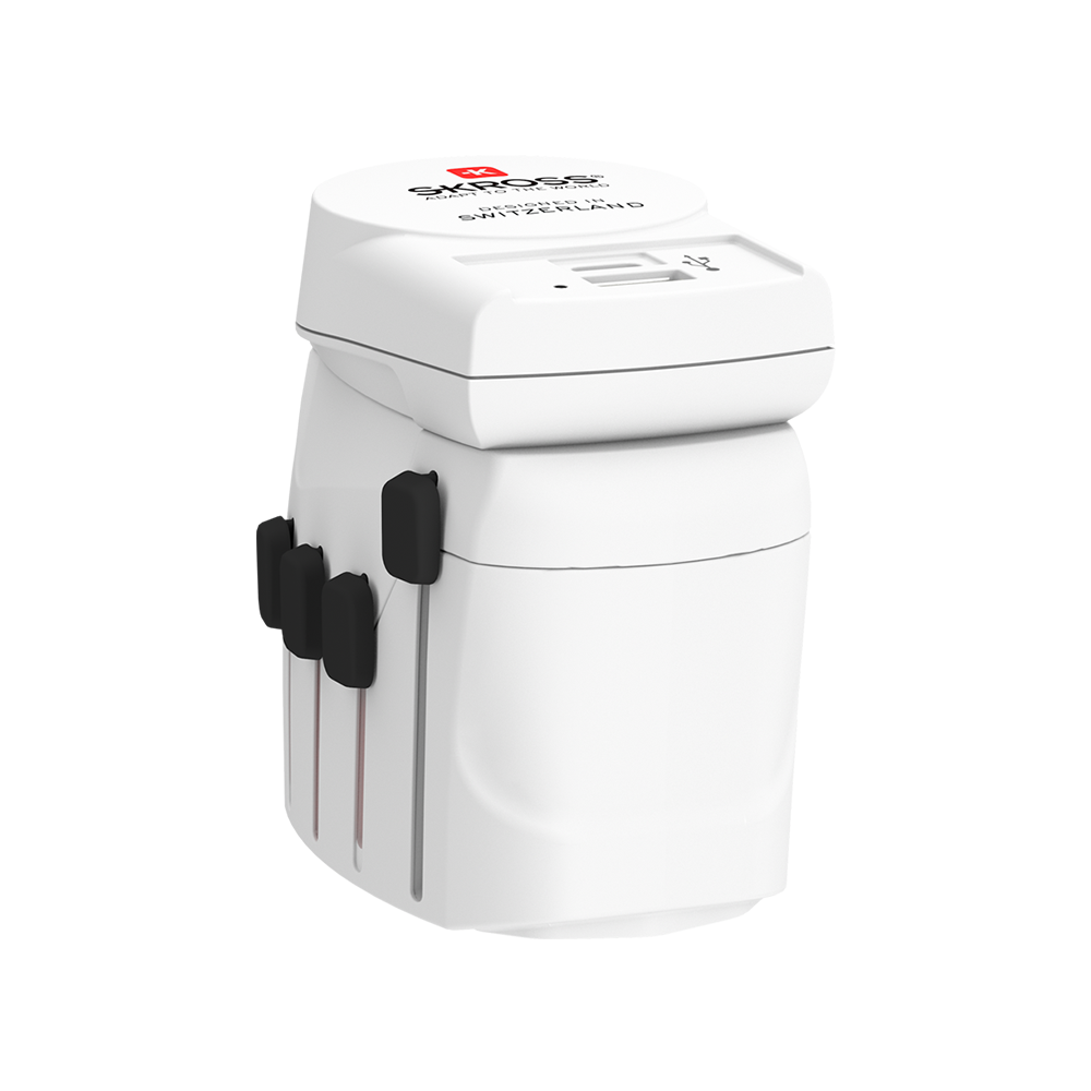 A skiross travel adaptor is sitting on top of a white surface.