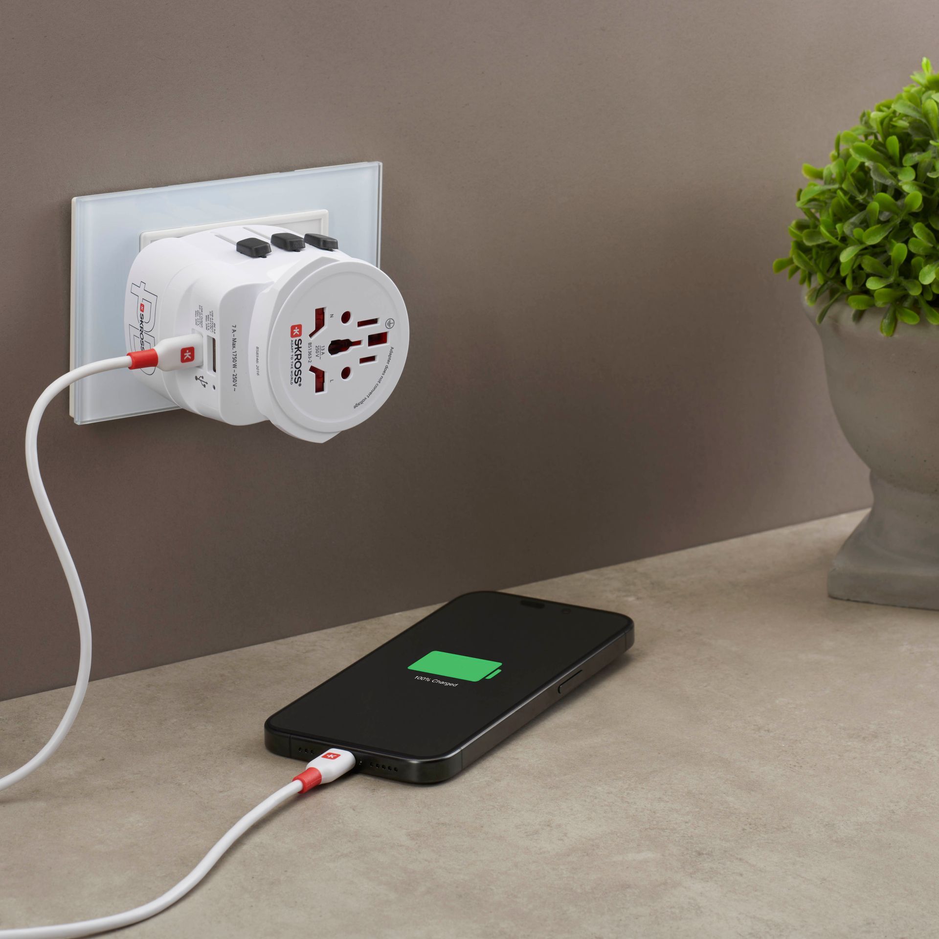 Skross 3-Pole PRO Light USB AC45PD - World Travel Adapter charging a phone SKR-0249