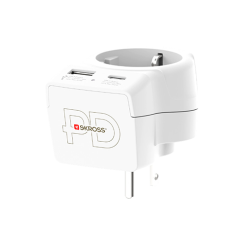 White travel adapter with USB ports and a plug, angled view.