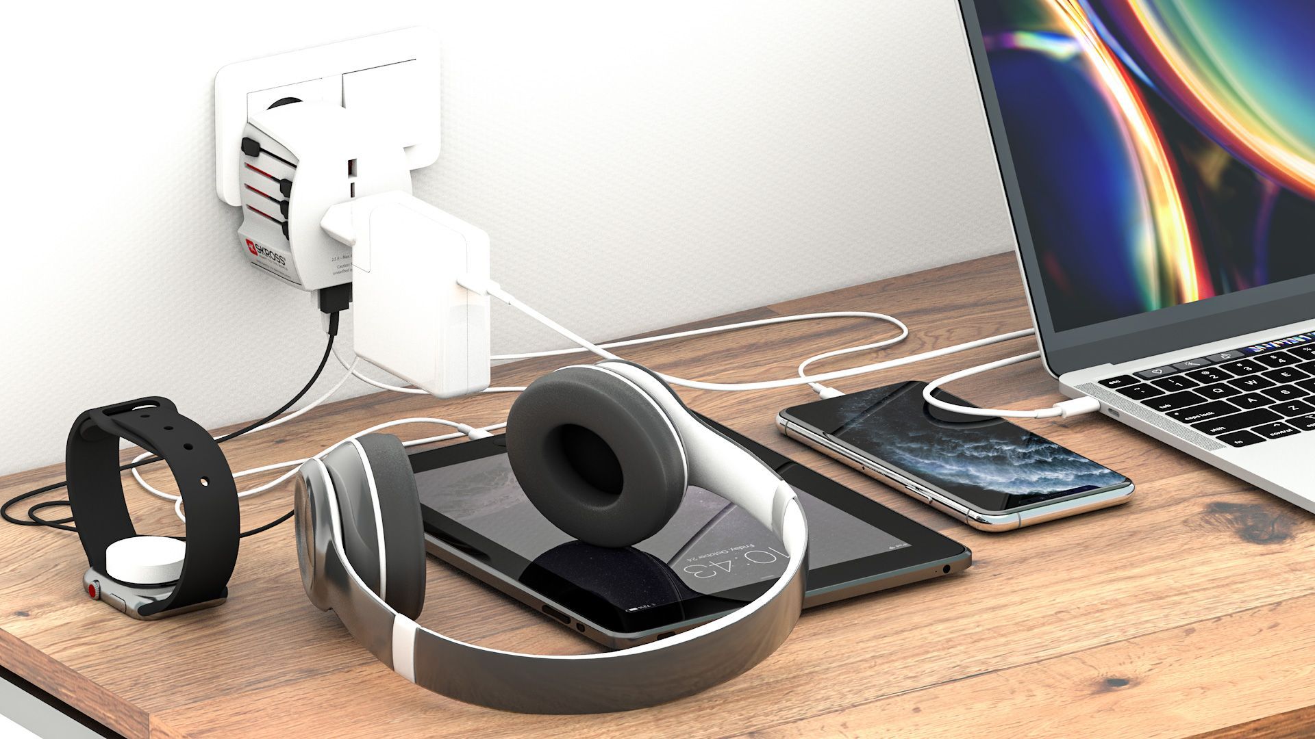 A wooden desk with a laptop , headphones , a watch , and a tablet.