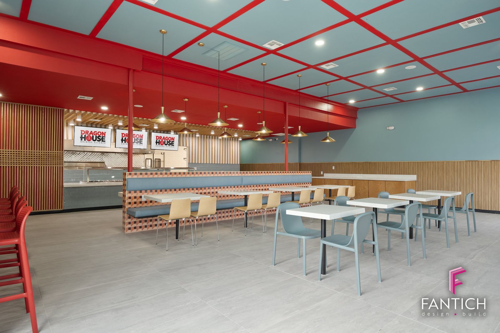 Modern fast-food restaurant interior with red ceiling accents, tables, chairs, and counter seating