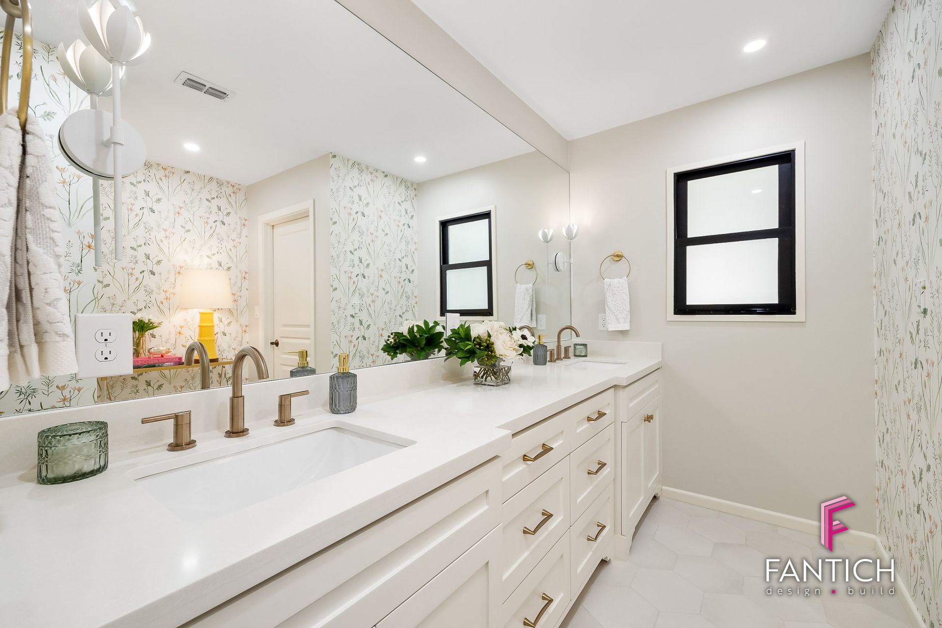 Bright modern bathroom with double vanity, large mirror, and white tile walls