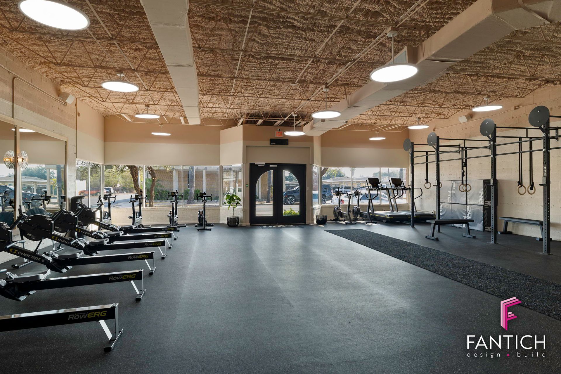 Spacious modern gym with treadmills, strength equipment, and a rubber workout floor